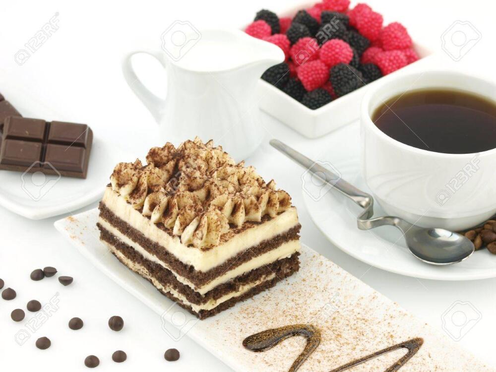 9102780-Tiramisu-dessert-and-a-cup-of-coffee-on-a-table--Stock-Photo.jpg.jpeg