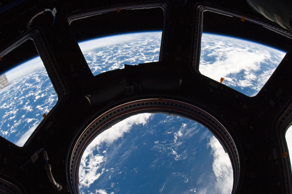 Earth_and_its_horizon_seen_through_the_windows_in_Cupola.jpg.jpeg