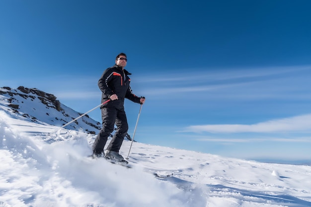 skier-sliding-down-the-mountain-on-the-snow-in-the-ski-resort_594511-414.jpg